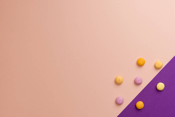 Круглый с разноцветными конфетками на цветном фоне
. - Фото, изображение