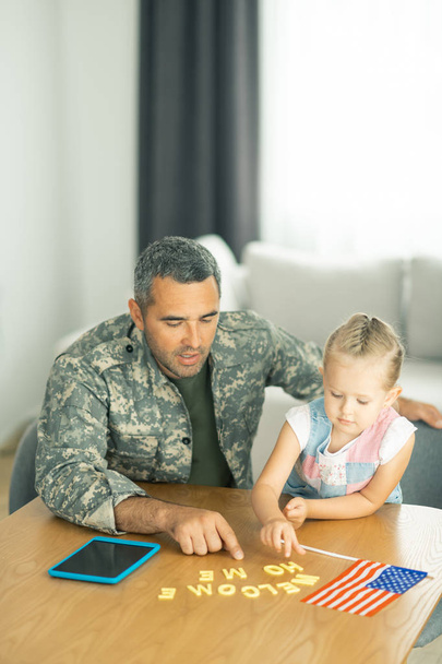 Military man coming back home and playing with daughter - Fotoğraf, Görsel
