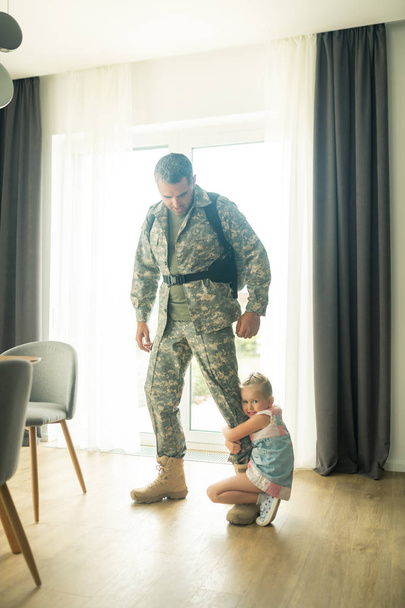 Man leaving home for military service saying goodbye to daughter - Φωτογραφία, εικόνα