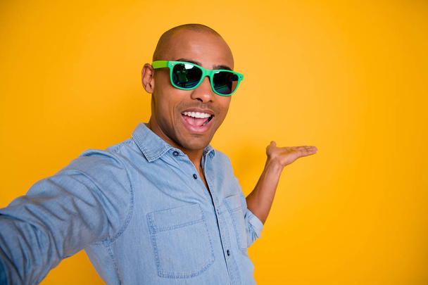 Close up photo of stylish trendy pretty guy feel excited have free time holidays showing make photo isolated over yellow background - Fotoğraf, Görsel