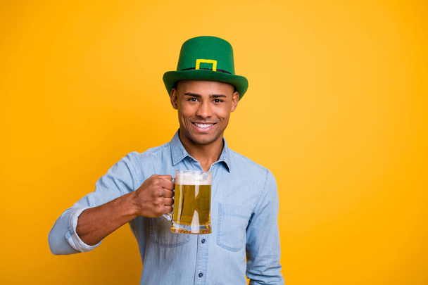 Photo of dark skin amazing guy hand beer glass lets drink to us tradition culture day wear jeans denim shirt isolated bright yellow background - Fotografie, Obrázek