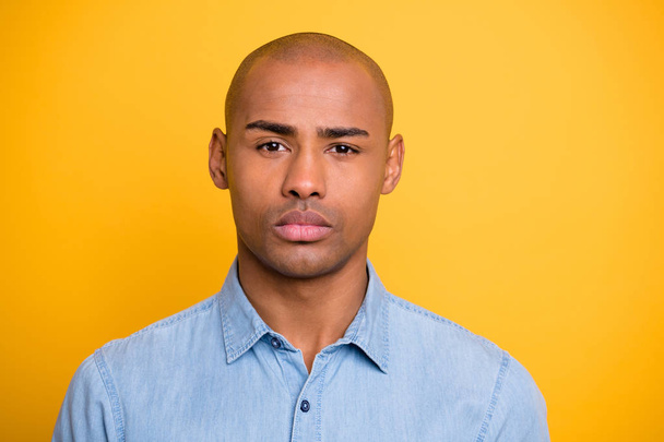 Photo of dark skin macho not smiling moody wear jeans denim shirt isolated bright yellow background - Фото, изображение