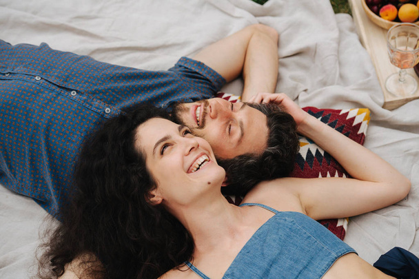 Couple in love, enjoing each other's company during picnic on lawn - Photo, Image