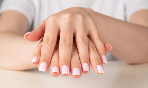 female hand with light pink nail design - 写真・画像