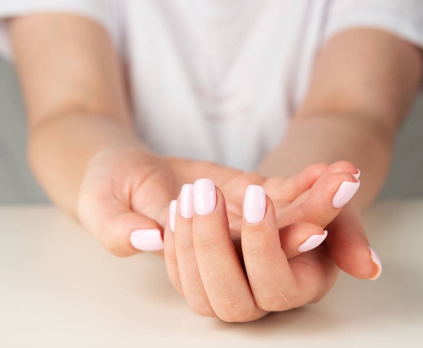 female hand with light pink nail design - Foto, Imagem