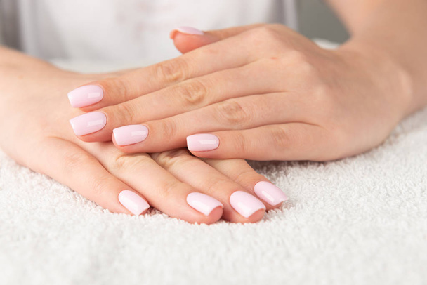female hand with light pink nail design - Foto, Bild