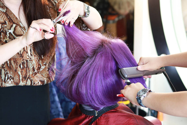 cutting and ironing on violet hair - Photo, Image