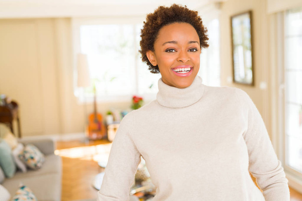 Beautiful young african american woman smiling confident to the  - 写真・画像