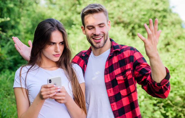 Woman use mobile phone. Mobile addicted. Social networks. Surfing internet. Buy online. Internet dependence. Guy and girl nature smartphone. She always online. Man jealous girlfriend messaging online - Valokuva, kuva
