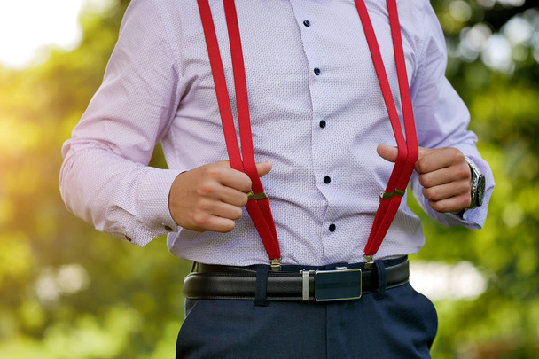 red stylish men's suspenders on blue shirt background - Foto, Bild