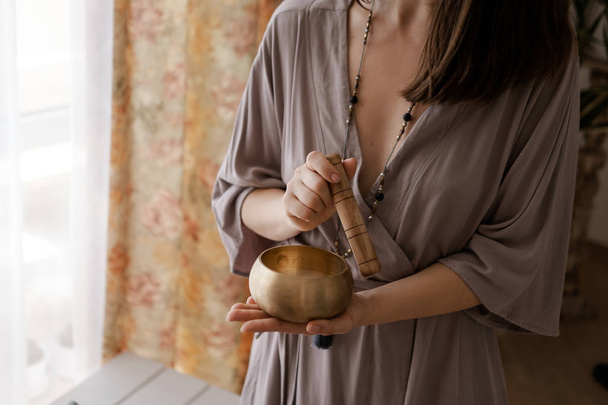 Woman holding in hands singing bowl  - Photo, Image