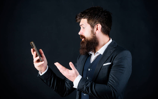 Man formal suit use smartphone social networks. Guy surfing internet smartphone. Online service and application. Video call. Modern technologies. Businessman well groomed man hold smartphone - 写真・画像