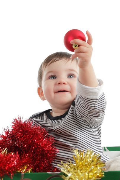 Pretty baby girl holding a christmas ball - Photo, Image