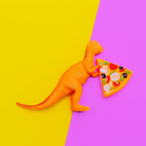 Plastic dinosaur with pizza. Fast food concept art - Photo, image