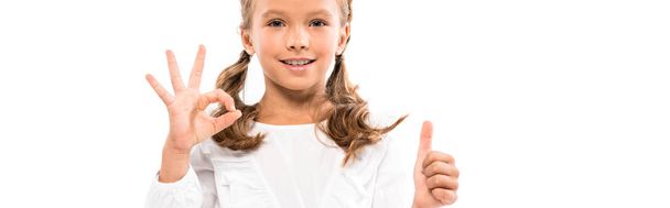 panoramic shot of happy kid showing thumb up and ok sign isolated on white  - Foto, imagen