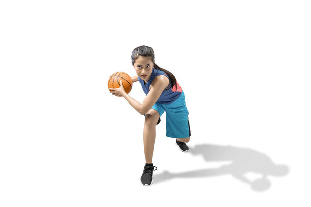 Asian woman basketball player in action with the ball  - Фото, изображение