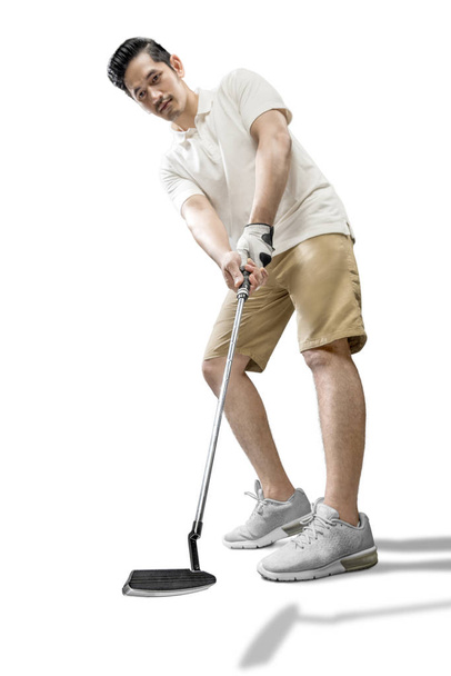Asian man swing the putter golf club - 写真・画像