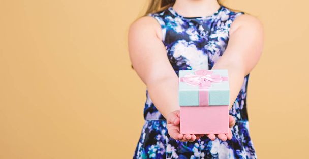 Share and generosity. Thank you so much. Child hold gift box beige background. Kid girl delighted gift. Girl adorable celebrate birthday. Kid happy loves birthday gifts. Shopping and holidays - 写真・画像