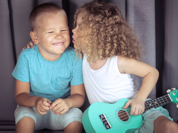 Portrait of a cute kids with ukulele - Valokuva, kuva