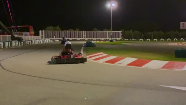 carreras de karts en una pista de carreras por la noche
  - Metraje, vídeo