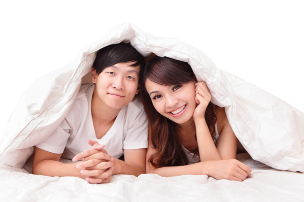 Young lovely couple lying in a bed - Foto, Imagen