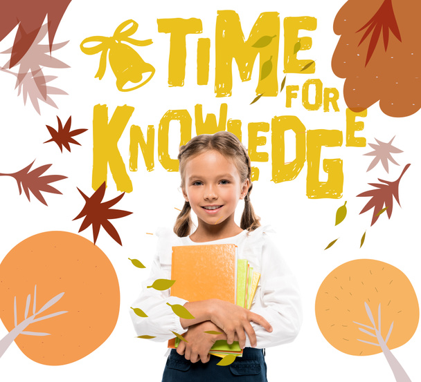 happy schoolkid holding books near time for knowledge lettering on white  - Photo, Image