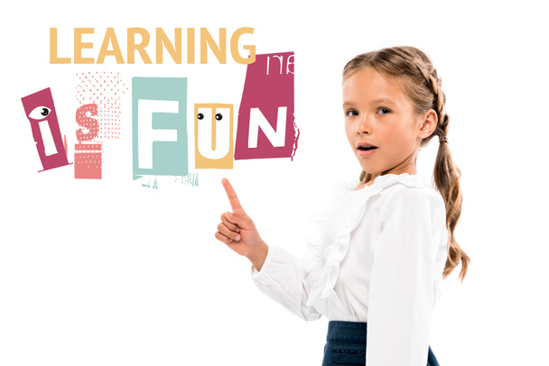 adorable kid pointing with finger at learning is fun lettering on white  - Photo, Image