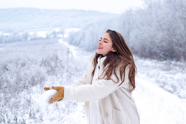 Snowball game. Playing with snow and having fun in winter park. Activity smiling girl in winter travel. Snowball game in winter holiday. Enjoying the weather and snow. - 写真・画像