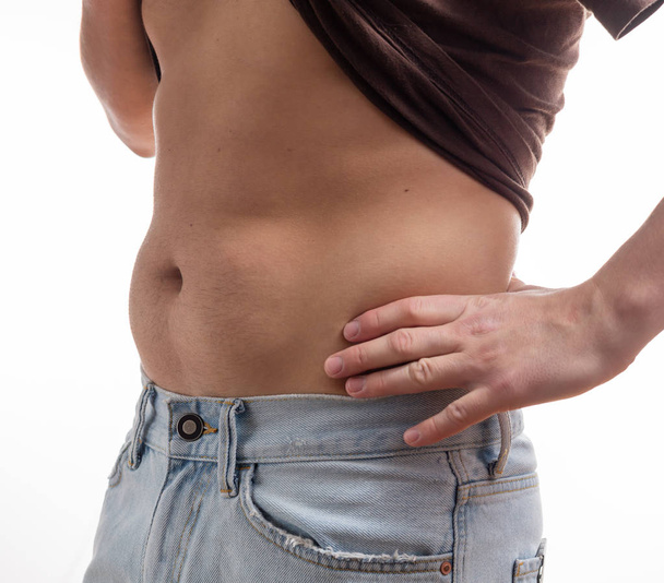 Male fat belly abdomen in tight jeans overweight on isolated white background - Photo, Image