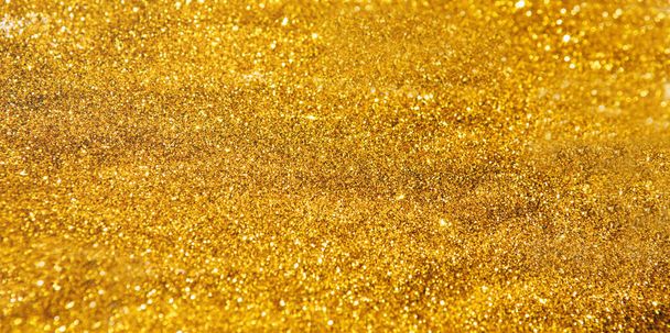Decorative golden glitter lights background, Christmas and New Year party concept - Photo, Image