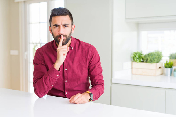 Handsome hispanic business man asking to be quiet with finger on lips. Silence and secret concept. - Fotoğraf, Görsel