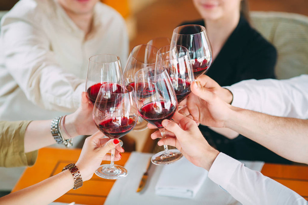 Lähikuva ystävien paahtaminen viinilasit juhlissa - Valokuva, kuva