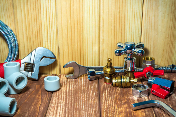 Ремонтные принадлежности и инструменты для сантехники на деревянном, античном фоне
. - Фото, изображение