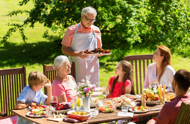 happy family having dinner or summer garden party - Фото, зображення