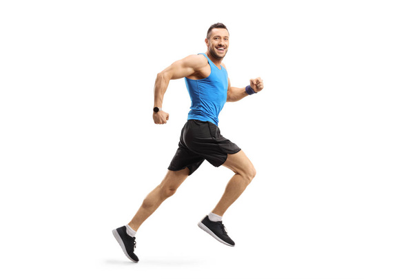 Young male in sportswear running and looking at the camera - Photo, Image