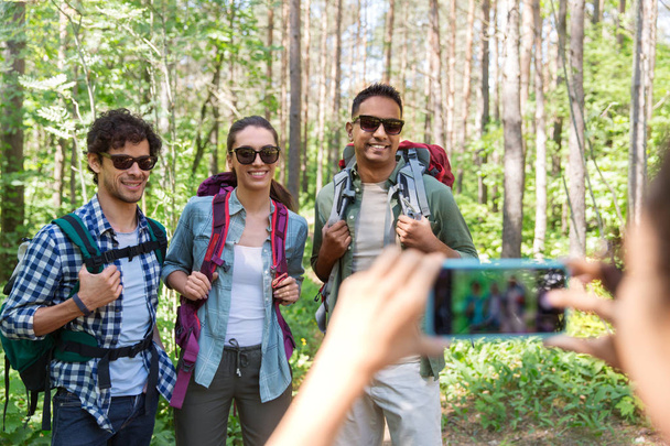 friends with backpacks being photographed on hike - 写真・画像