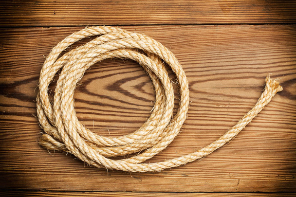 A jute rope on a wooden table - Fotografie, Obrázek