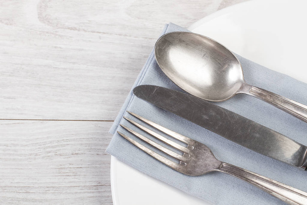 Vintage cutlery on a white plate - Фото, зображення