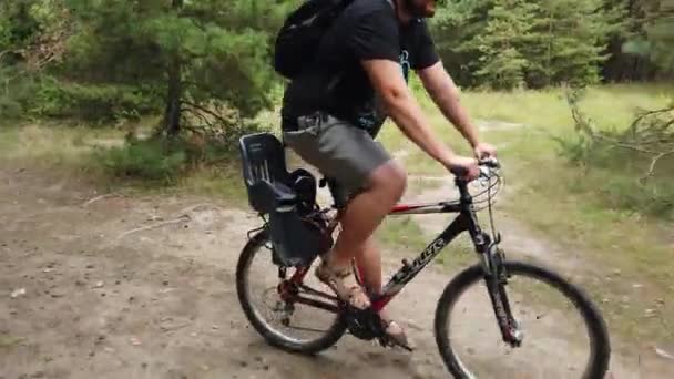 Kiev, Ukraine, Europe - August 2019: Bike ride on a forest road. A cyclist rides on a road in the forest. Bike tour through the woods. - Video