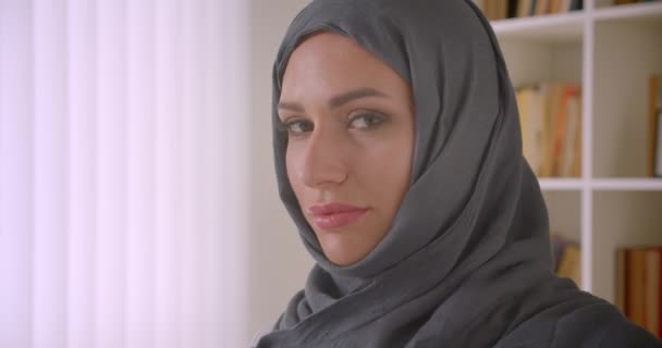 Closeup portrait of young successful muslim businesswoman in hijab looking at camera smiling cheerfully in office indoors - Materiał filmowy, wideo