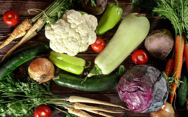 Top down view, heap of various vegetables on dark wooden board - Photo, Image