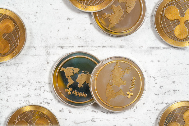 Top down view, XRP ripple cryptocurrency golden coins on white stone like board - Zdjęcie, obraz