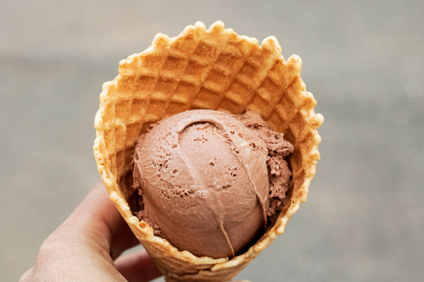Chocolate ice cream in a waffle cone - Фото, изображение