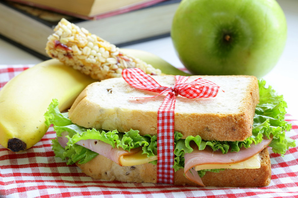 Sandwich with ham, apple, banana and granola bar - healthy eating, school lunch - Photo, Image