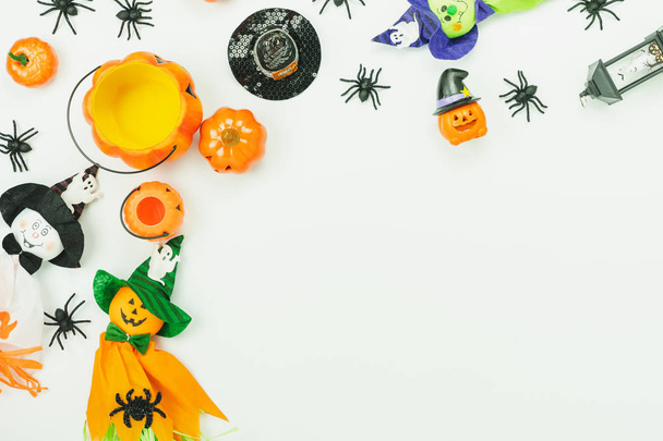 Table top view aerial image of decoration Happy Halloween day background concept.Flat lay accessories essential object to party the pumpkin & doll and hat on white wooden.Space for creative design. - Photo, Image
