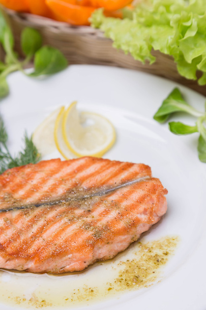 hot grilled salmon with garnish on white plate - Photo, Image