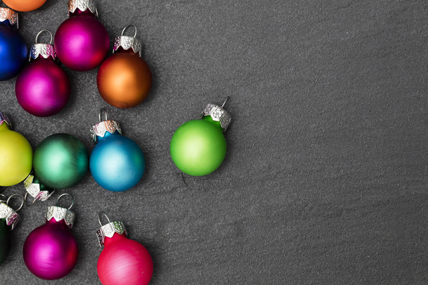 Festive Christmas baubles on a slate background - 写真・画像