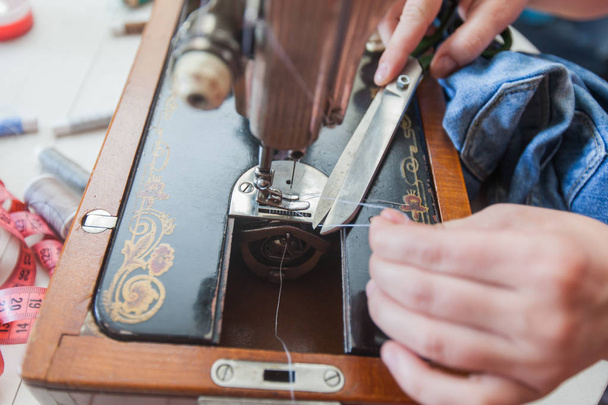  female tailor hands changing thread on old sewing machine - Photo, Image