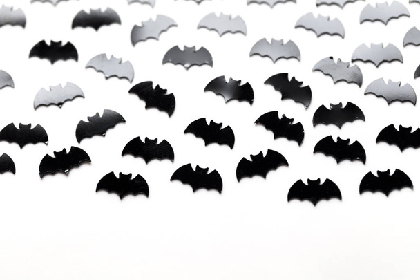 Black bat shapes on a white background. Halloween background - Φωτογραφία, εικόνα