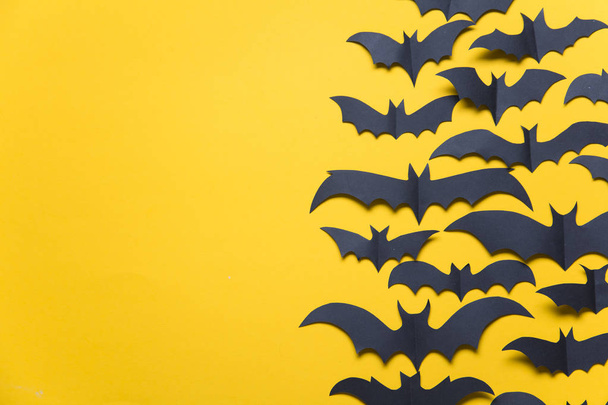 Halloween paper vampire bat decorations on an orange background. - Foto, immagini